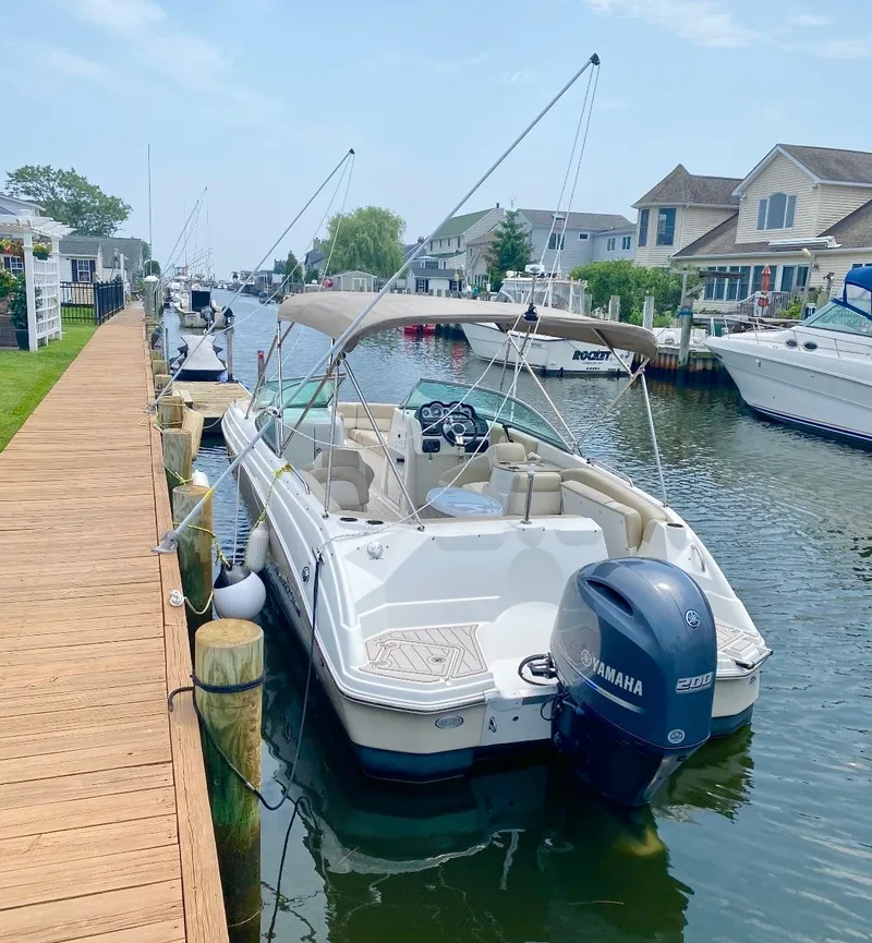 Slide: The Image of 2016 NauticStar Sport Deck 243DC boat docked at marina. - 2