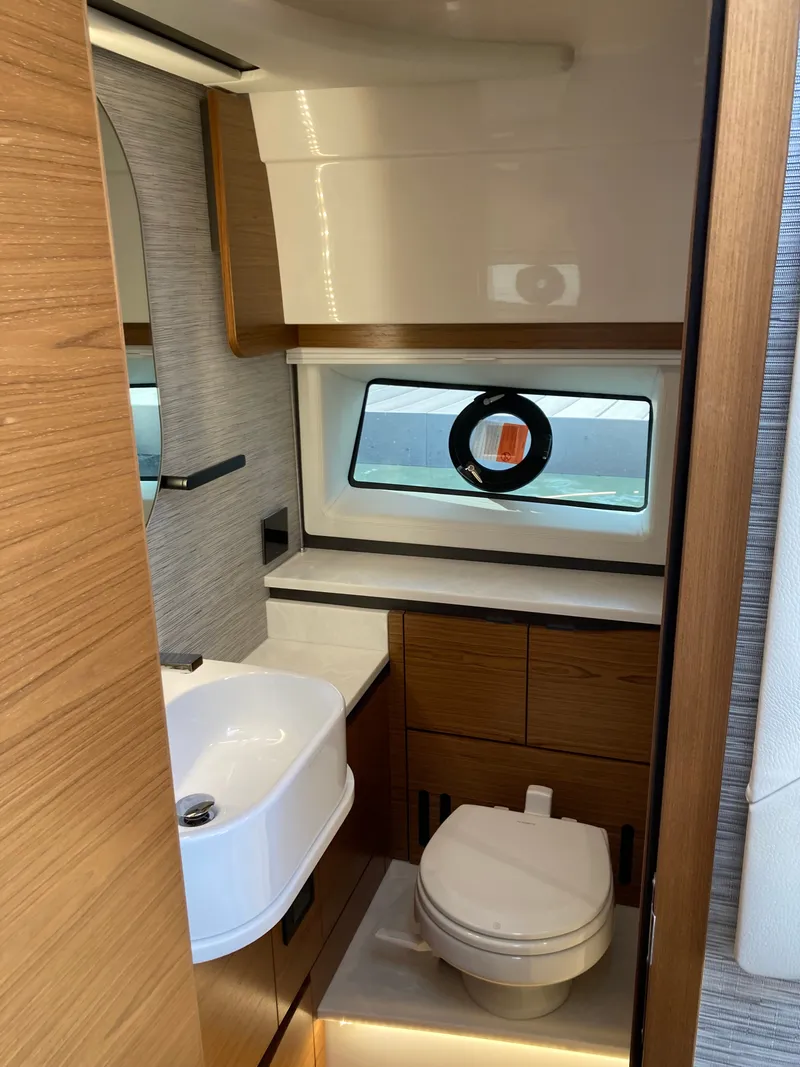 Slide: The Image of The image shows a modern yacht bathroom with a sink, toilet, and window. - 27