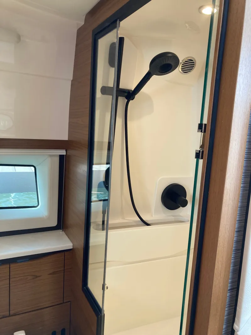 Slide: The Image of The shower in the 2027 Tiara Yachts 39LE features a glass door and modern fixtures. - 28