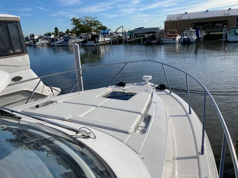 Slide: The Image of The image shows the foredeck of a 2027 Tiara Yachts 39LE in a marina. - 39