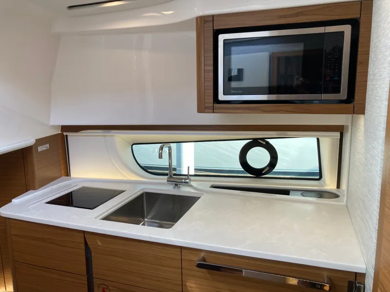 Slide: The Image of Modern galley with sink, stove, and microwave in a 2027 Tiara Yachts 39LE. - 32
