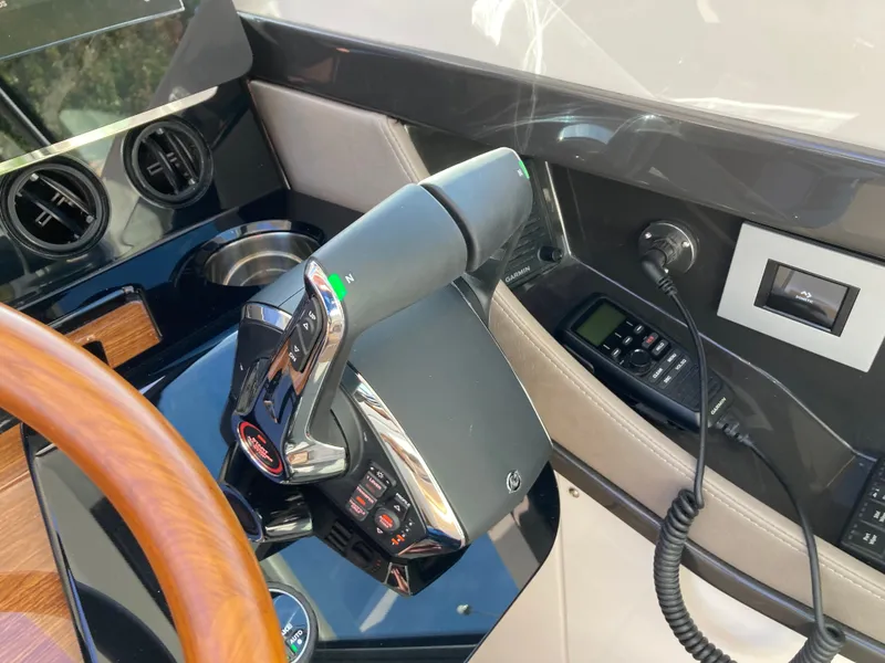 Slide: The Image of Close-up of the helm of a Tiara Yachts 39LE with modern controls and a wooden steering wheel. - 21