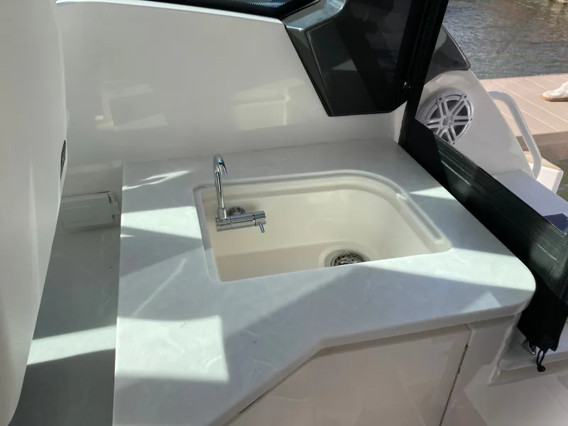 Slide: The Image of The 2027 Tiara Yachts 39LE features a sleek sink with a faucet on a smooth countertop. - 19