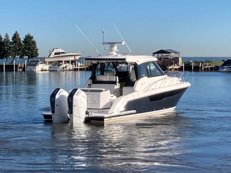Slide: The Image of Tiara Yachts 39LE 2027 on calm water, featuring twin outboard engines and a sleek design. - 53