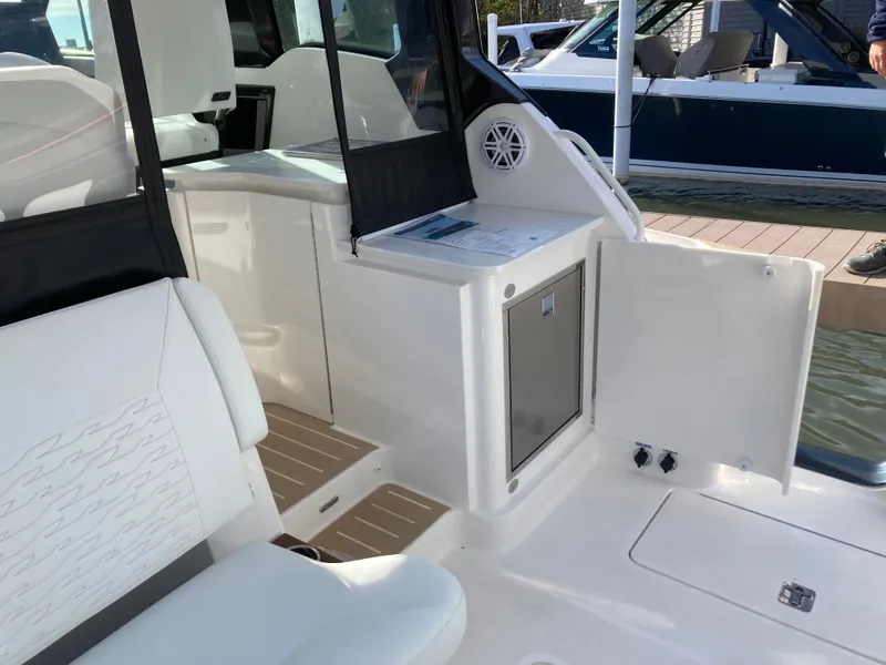 Slide: The Image of The image shows the cockpit of a 2027 Tiara Yachts 39LE with white seating and a small refrigerator. - 7