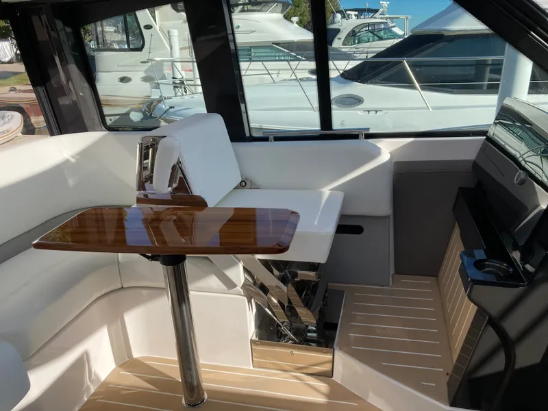 Slide: The Image of Interior of a 2027 Tiara Yachts 39LE with sleek wood finish and white upholstery. - 13