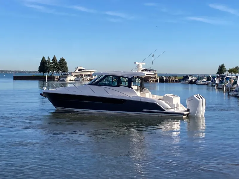 Slide: The Image of 2027 Tiara Yachts 39LE on calm water, featuring sleek design and twin outboard engines. - 50
