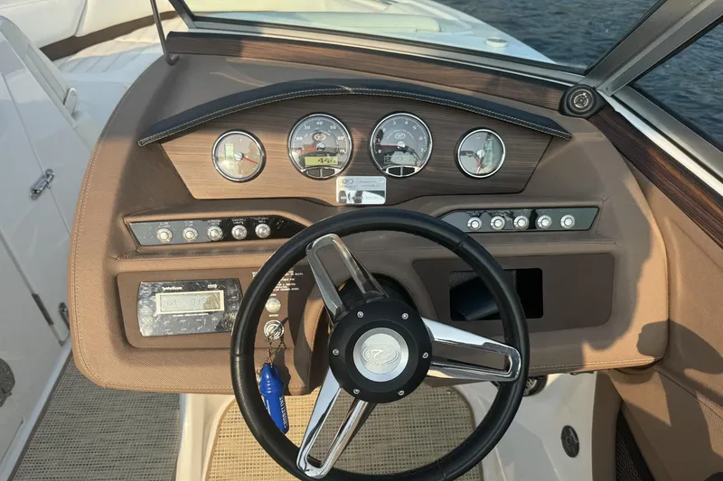 Slide: The Image of Steering console of a 2014 Cobalt R5 boat with gauges and controls. - 4
