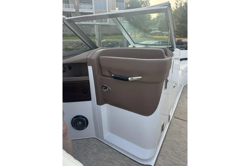 Slide: The Image of Interior view of a 2014 Cobalt R5 boat, featuring a brown door panel and speaker. - 5