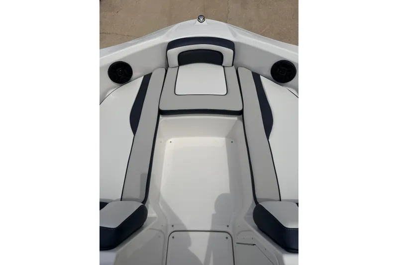 Slide: The Image of 2026 Yamaha Boats SX195 interior seating with sleek white and navy design. - 11