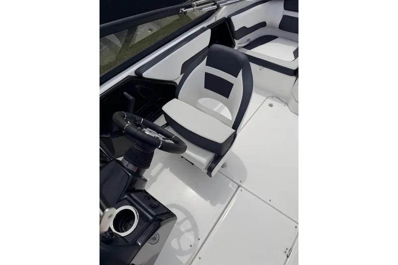 Slide: The Image of Interior of 2026 Yamaha Boats SX195, featuring sleek seating and modern steering console. - 13