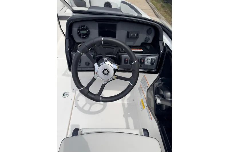 Slide: The Image of Steering wheel and dashboard of 2026 Yamaha Boats SX195, showcasing controls and instrumentation. - 18