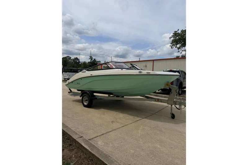 Slide: The Image of 2026 Yamaha Boats SX195 on trailer, parked outdoors under cloudy sky. - 6