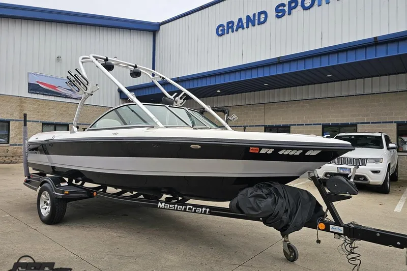 Slide: The Image of 2005 MasterCraft X-2 boat on trailer outside Grand Sport dealership. - 10
