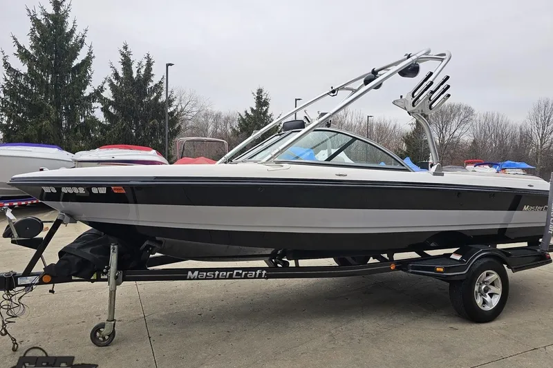 Slide: The Image of 2005 MasterCraft X-2 boat on trailer, parked outdoors, ready for water sports. - 17