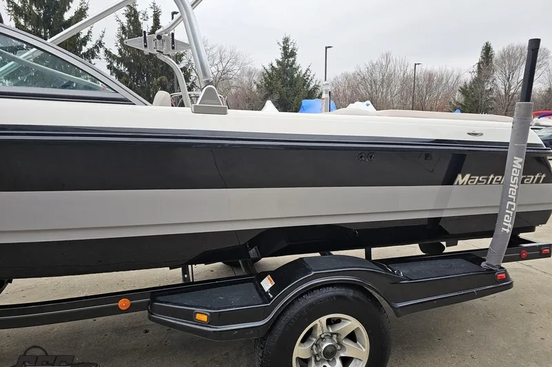 Slide: The Image of 2005 MasterCraft X-2 boat on trailer, side view with trees in background. - 21