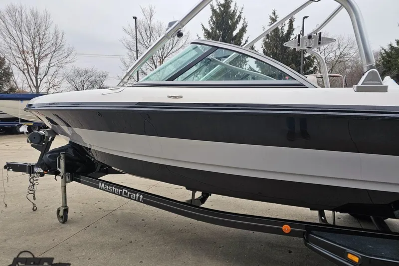 Slide: The Image of 2005 MasterCraft X-2 boat on trailer, sleek design, parked outdoors. - 22