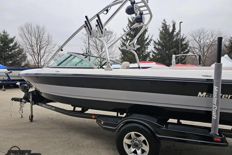 Slide: The Image of 2005 MasterCraft X-2 boat on trailer, featuring sleek design and wakeboard tower. - 23