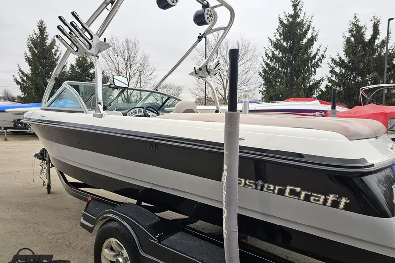 Slide: The Image of 2005 MasterCraft X-2 boat on trailer, featuring sleek design and wakeboard tower. - 24