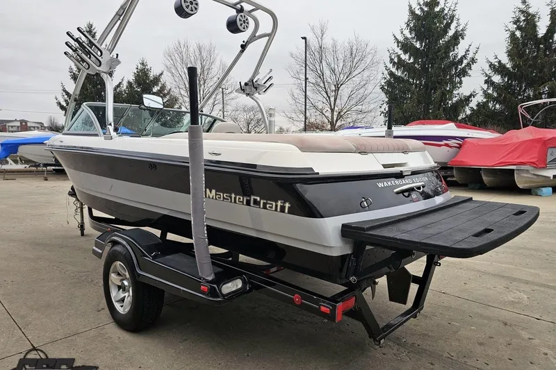 Slide: The Image of 2005 MasterCraft X-2 wakeboard boat on trailer, parked outdoors. - 25