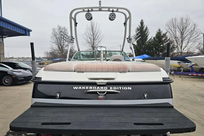 Slide: The Image of 2005 MasterCraft X-2 Wakeboard Edition boat with tower speakers, parked outdoors. - 28