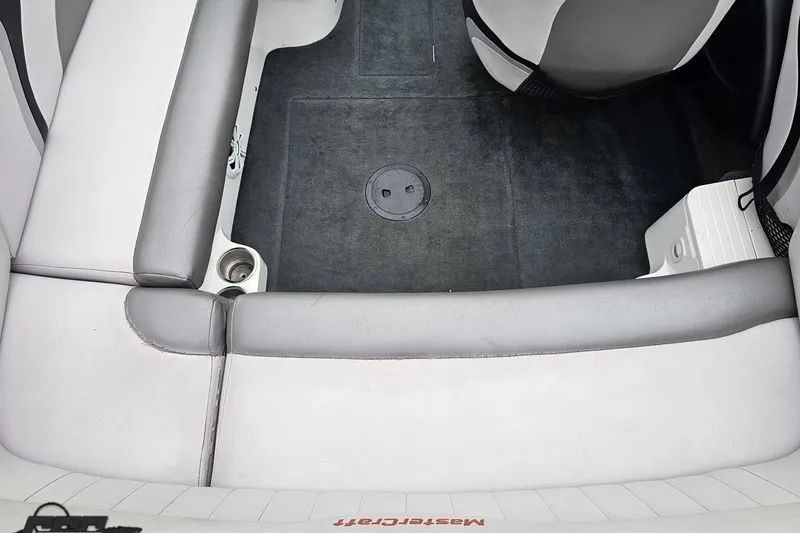 Slide: The Image of 2005 MasterCraft X-2 boat interior with gray seating and carpeted floor. - 35