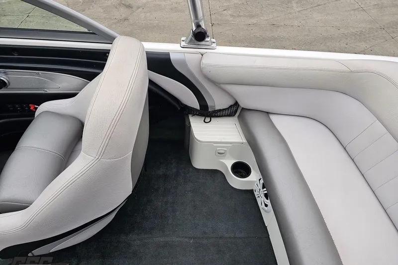 Slide: The Image of 2005 MasterCraft X-2 boat interior with gray seating and cup holders. - 40