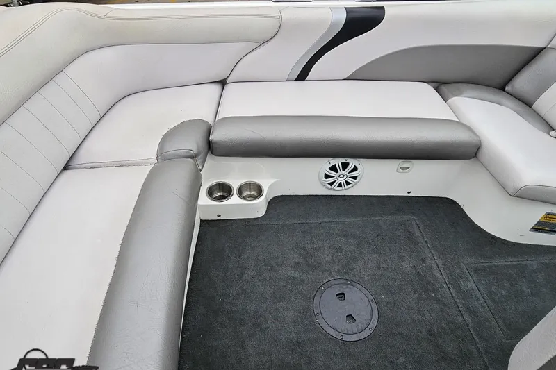 Slide: The Image of 2005 MasterCraft X-2 boat interior with gray seating, cup holders, and speaker. - 42