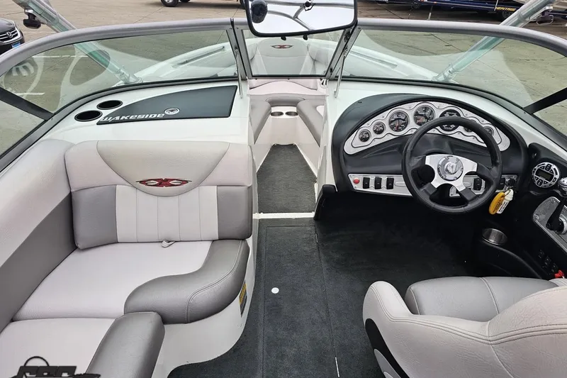 Slide: The Image of Interior of a 2005 MasterCraft X-2 boat, featuring sleek dashboard and seating. - 46