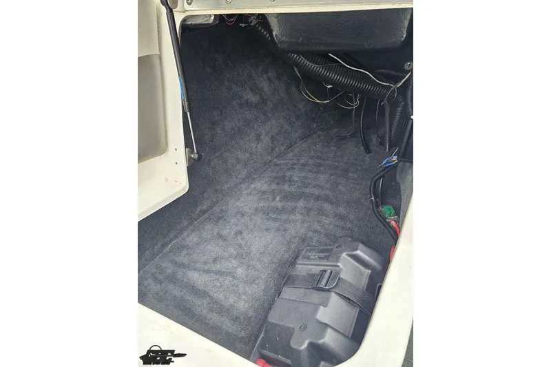 Slide: The Image of Interior view of a 2005 MasterCraft X-2 boat compartment with wiring and battery. - 49