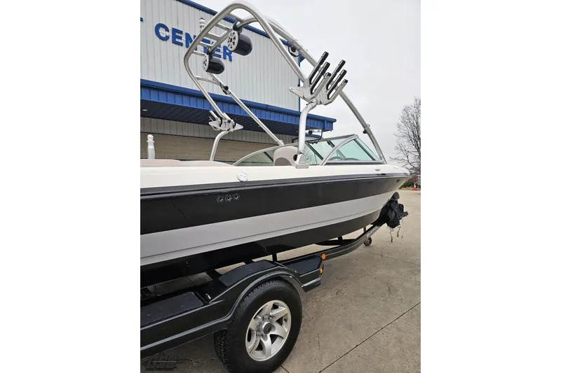 Slide: The Image of 2005 MasterCraft X-2 boat on trailer, parked outside a service center. - 5