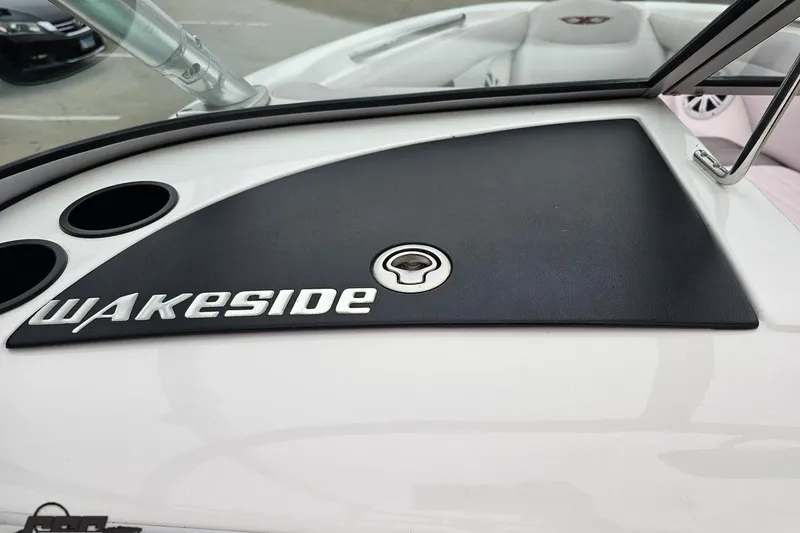 Slide: The Image of 2005 MasterCraft X-2 boat dashboard with "Wakeside" branding and cup holders. - 50