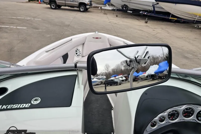 Slide: The Image of 2005 MasterCraft X-2 boat interior with rearview mirror reflecting parked boats and vehicles. - 52