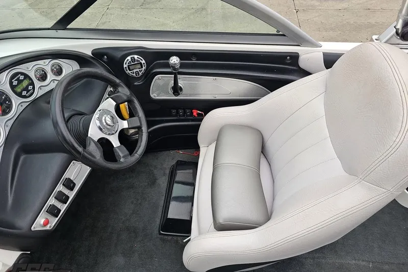 Slide: The Image of Interior of a 2005 MasterCraft X-2 boat, featuring steering wheel and dashboard controls. - 57