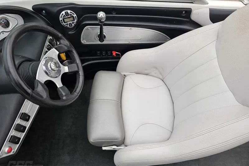 Slide: The Image of Interior of a 2005 MasterCraft X-2 boat, featuring steering wheel and control panel. - 58