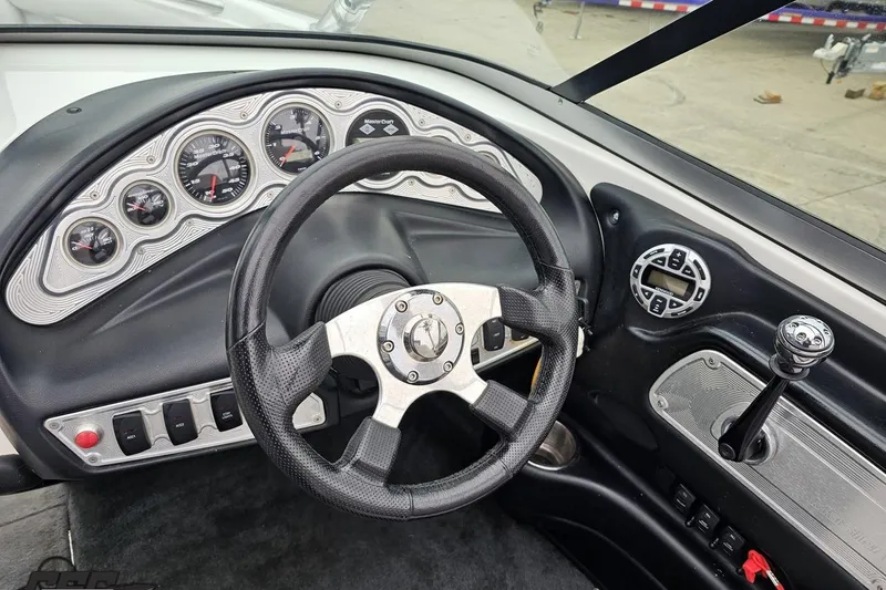 Slide: The Image of Dashboard of a 2005 MasterCraft X-2 boat with steering wheel and gauges. - 59