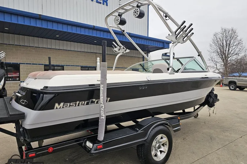 Slide: The Image of 2005 MasterCraft X-2 boat on trailer, parked outside a building. - 6