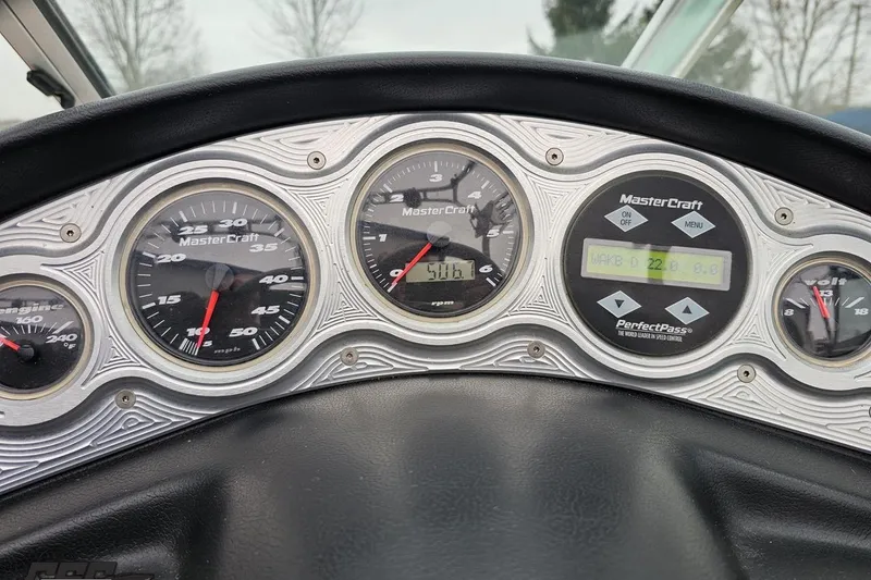Slide: The Image of Dashboard of a 2005 MasterCraft X-2 boat with speed and engine gauges. - 60