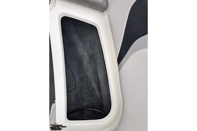 Slide: The Image of Interior compartment of a 2005 MasterCraft X-2 boat, featuring black carpet lining. - 66
