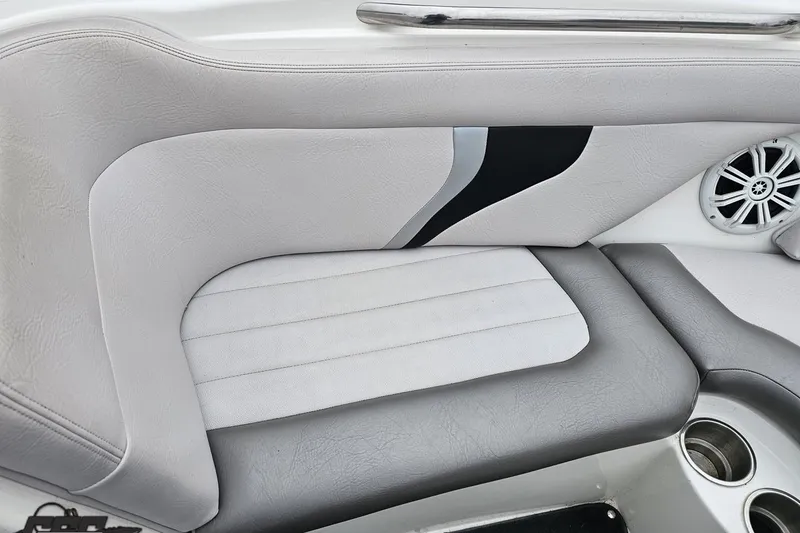 Slide: The Image of 2005 MasterCraft X-2 boat interior with gray and white seating, speaker, and cup holders. - 67
