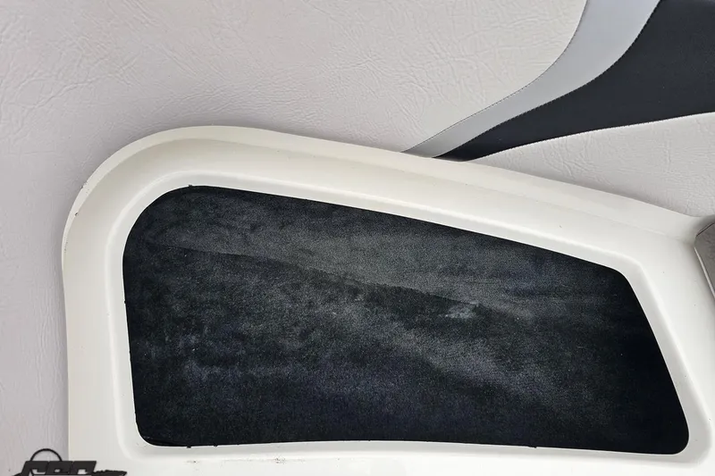 Slide: The Image of Interior detail of a 2005 MasterCraft X-2 boat, featuring a sleek black and white design. - 68