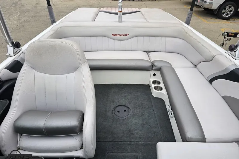 Slide: The Image of 2005 MasterCraft X-2 boat interior with gray seating and cup holders. - 72