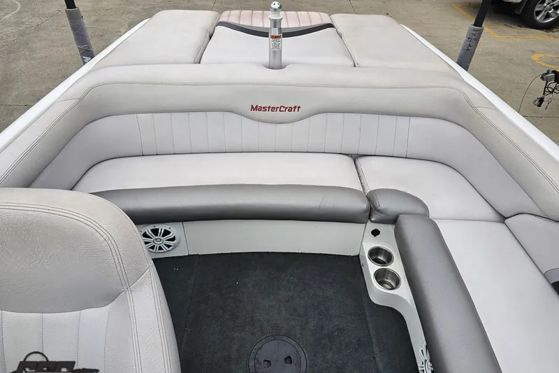 Slide: The Image of 2005 MasterCraft X-2 boat interior with gray seating and cup holders. - 73