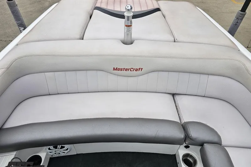 Slide: The Image of 2005 MasterCraft X-2 boat interior with cushioned seating and branded upholstery. - 74