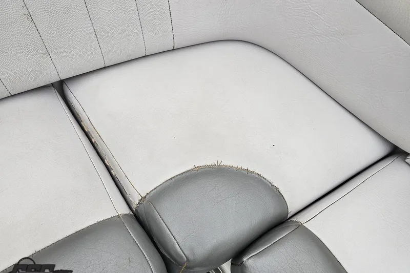 Slide: The Image of Worn upholstery on 2005 MasterCraft X-2 boat seat, showing visible stitching and wear. - 77