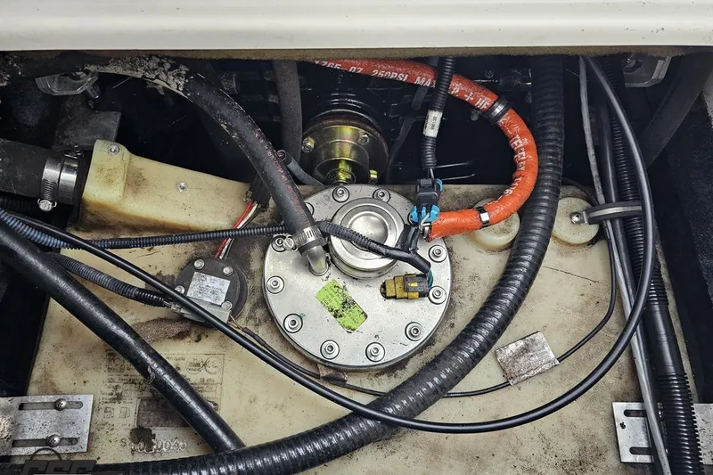 Slide: The Image of Engine compartment of a 2005 MasterCraft X-2 boat, showing fuel system components and wiring. - 79