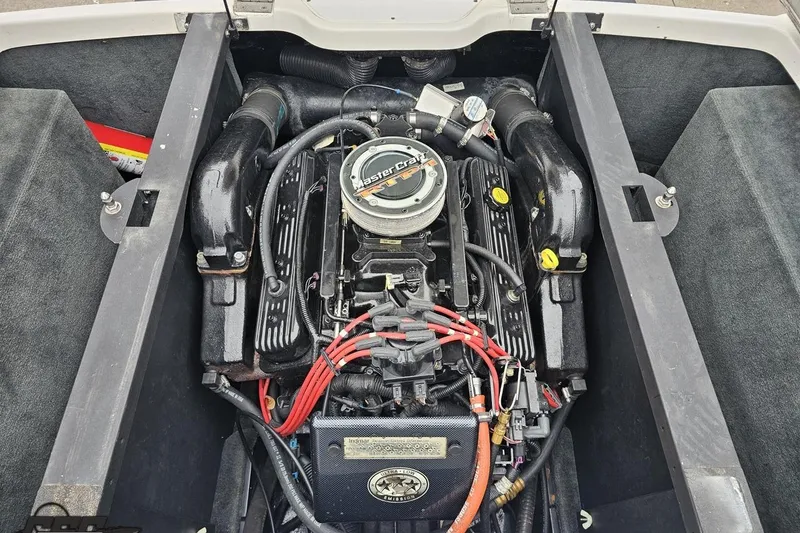 Slide: The Image of 2005 MasterCraft X-2 engine compartment with visible components and wiring. - 83