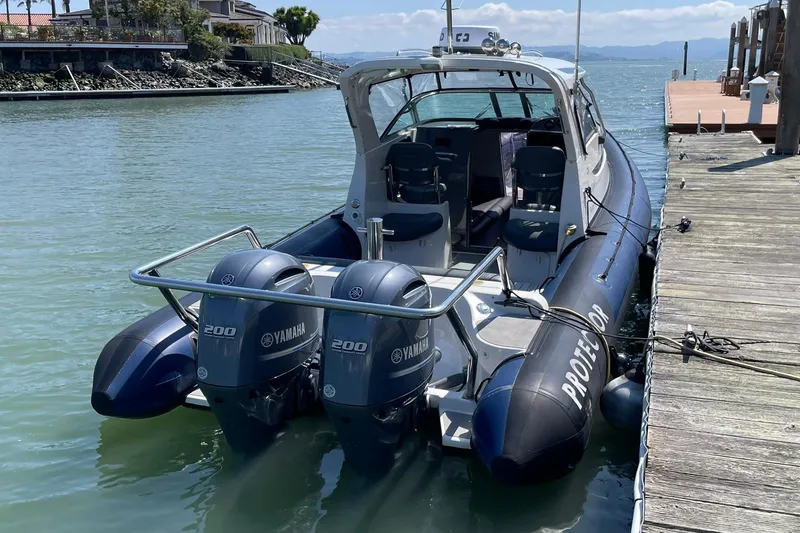 The Image of 2006 Protector Targa 28 boat docked, featuring dual Yamaha 200 engines. - 0