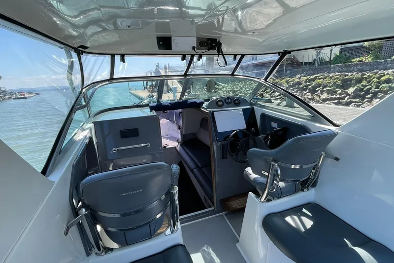 Slide: The Image of Interior view of a 2006 Protector Targa 28 boat, showcasing helm and seating area. - 11