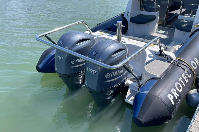 Slide: The Image of 2006 Protector Targa 28 boat with dual Yamaha 200 engines on calm water. - 14